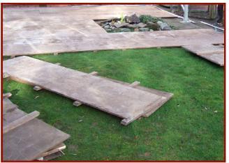 Wooden boarded floor being laid around small fountain 1