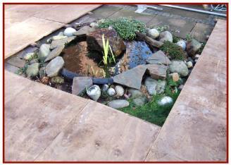 Wooden boarded floor being laid around small fountain 2